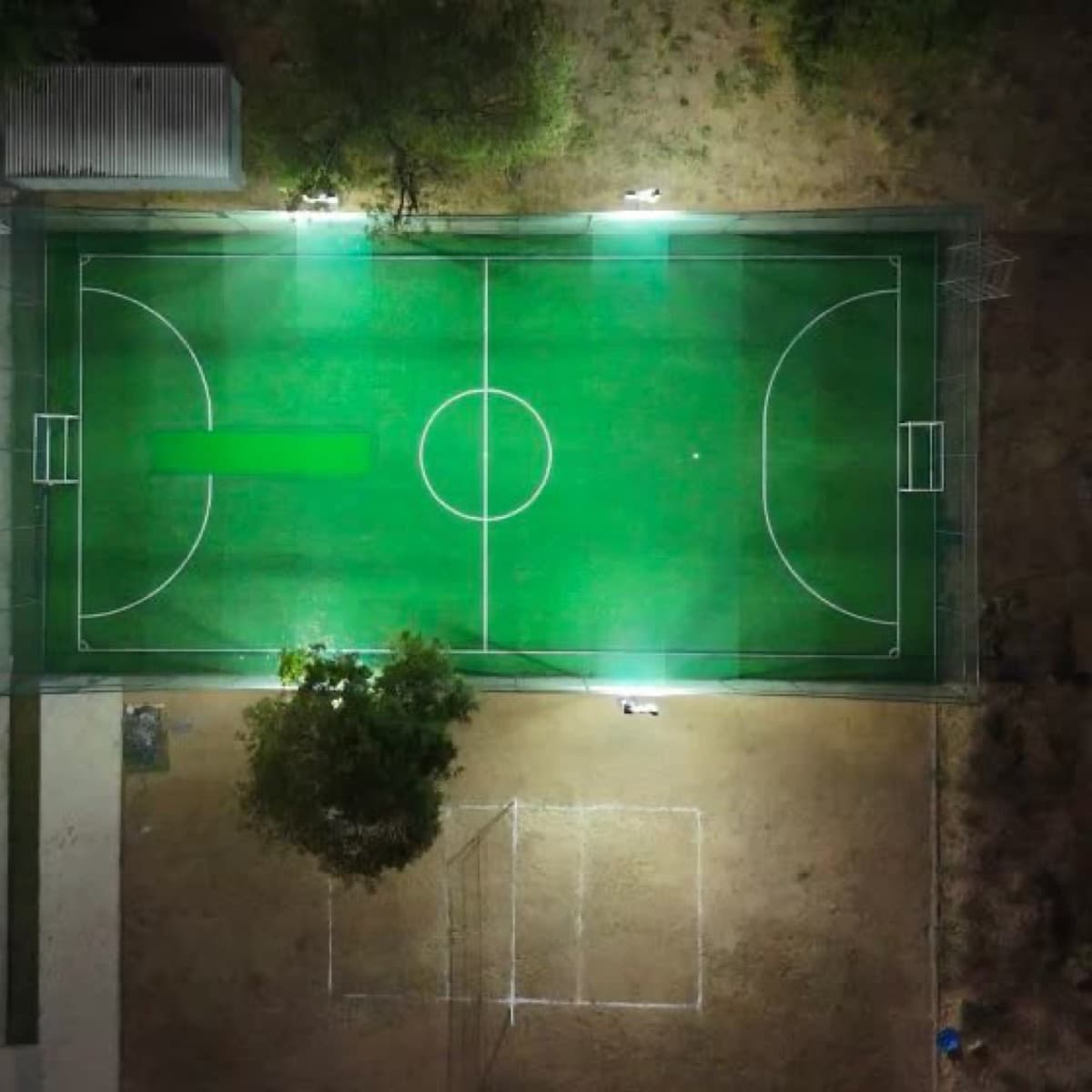 Floodlit turf pitch used for box cricket at Drona Sports Academy
